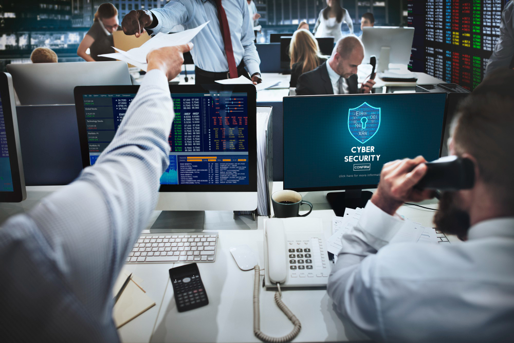 Analysts monitoring real-time security data on office screens