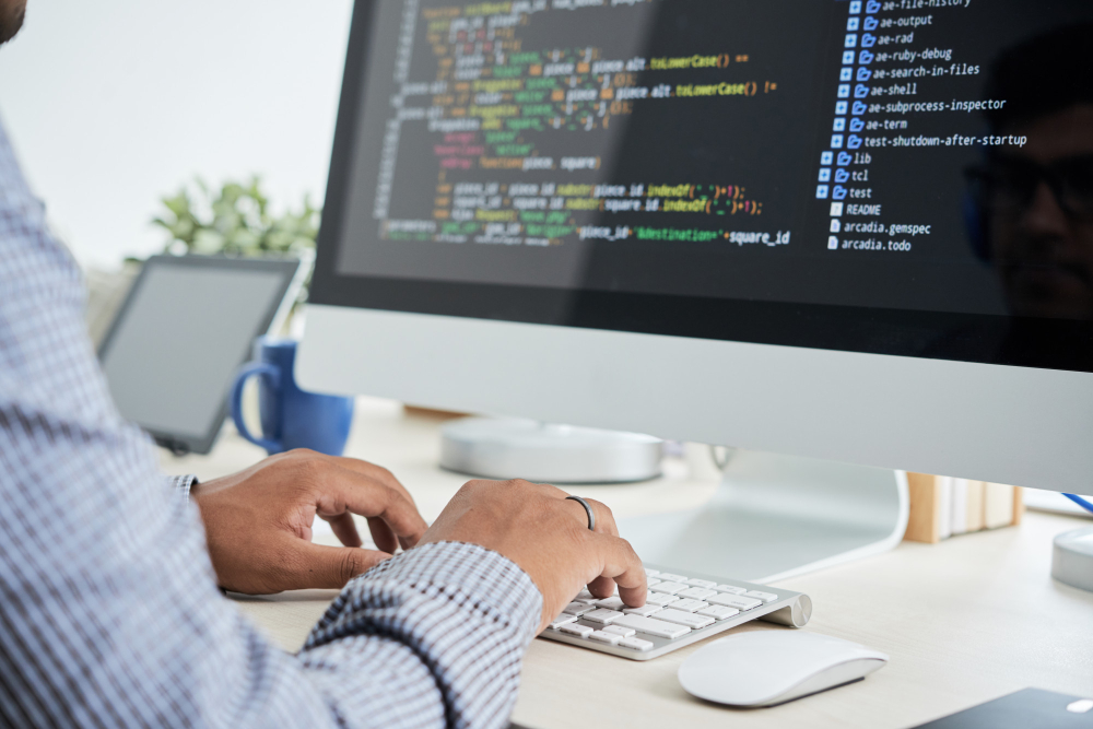 Developer reviewing .NET source code on multiple screens