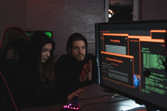 Developer working with C/C++ code on multiple screens