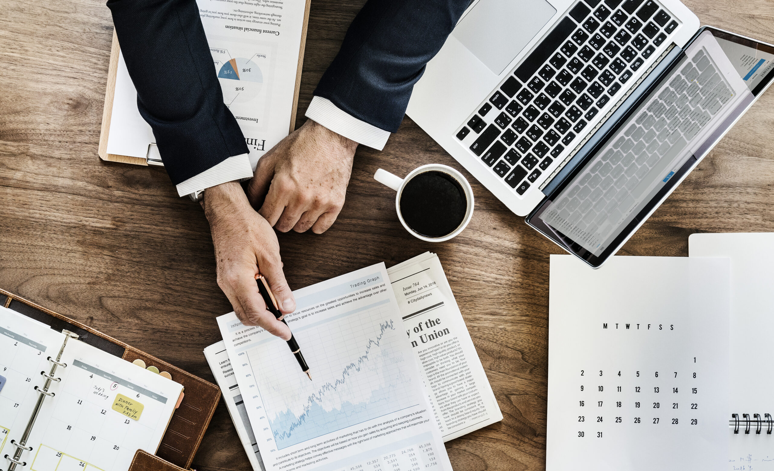 Aerial view of business data analysis charts on a desk