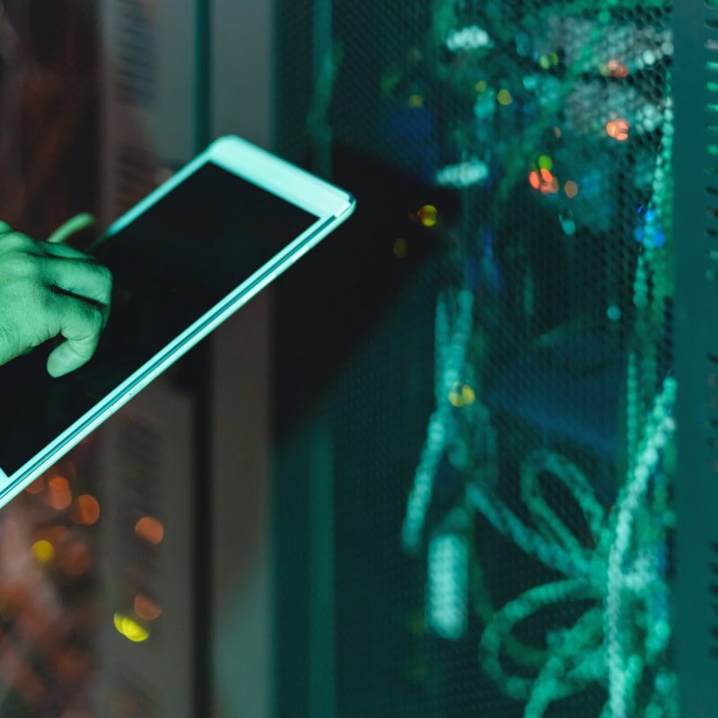 Männlicher Informatikingenieur arbeitet im Serverraum an der Datenbank.